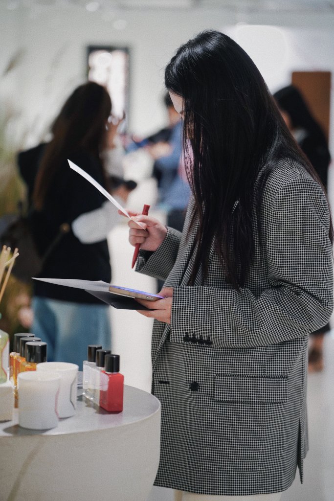 A guest marking her ballot beside the displays