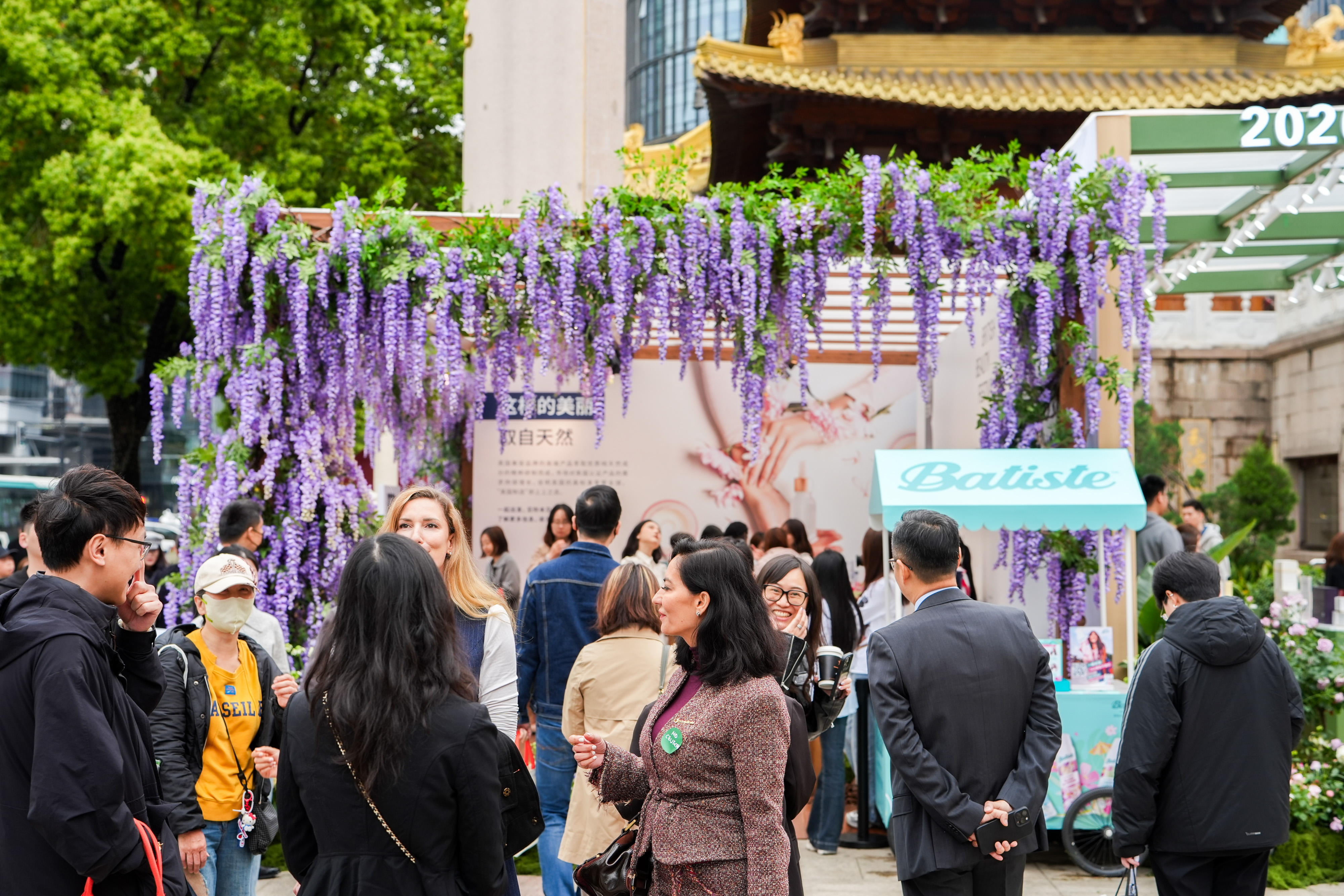 Guests at the Batiste cart beneath the wisteria.