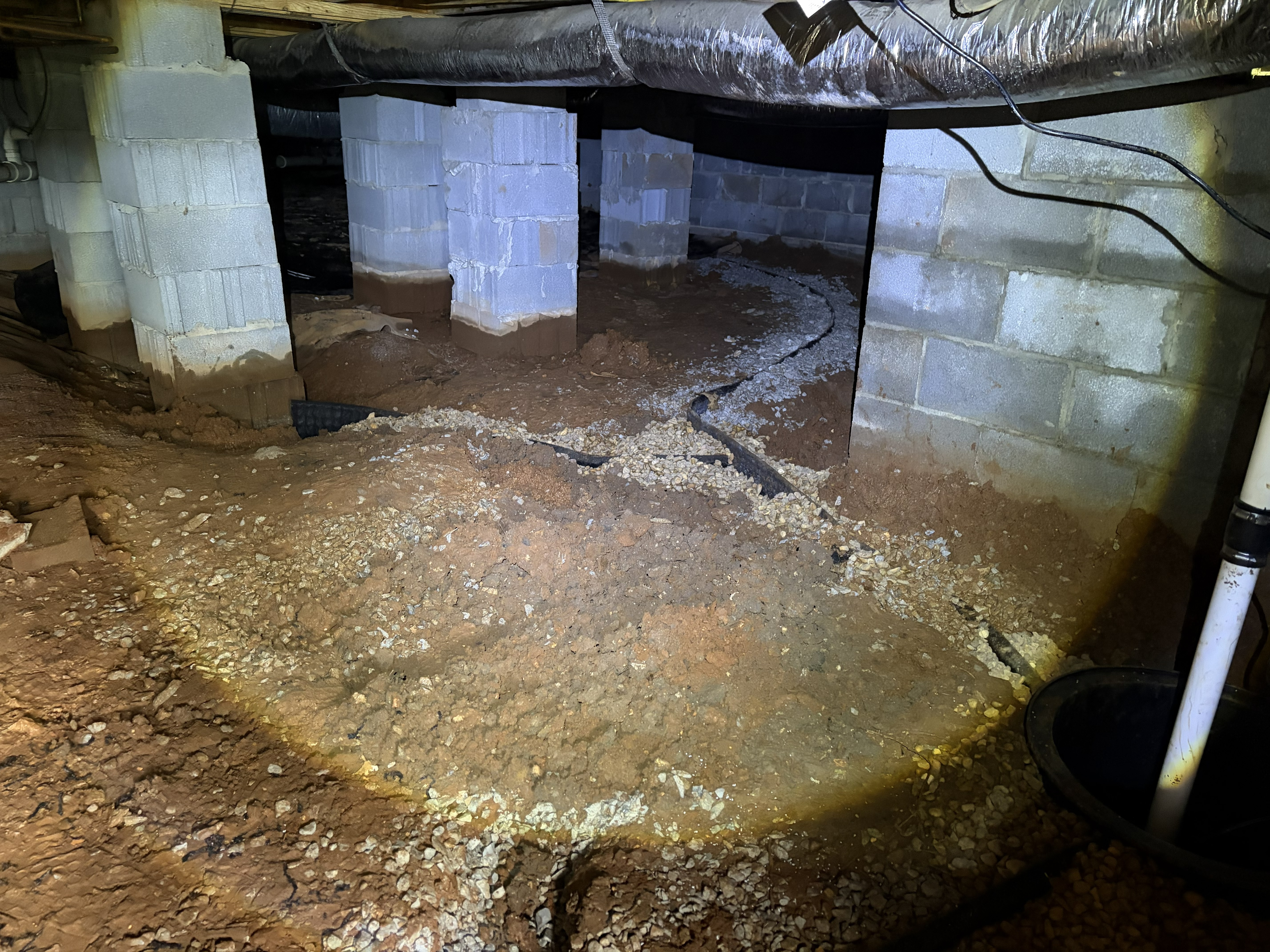 Crawl space water mitigation and sump pump installation with a drainage line in a Murfreesboro, TN home
