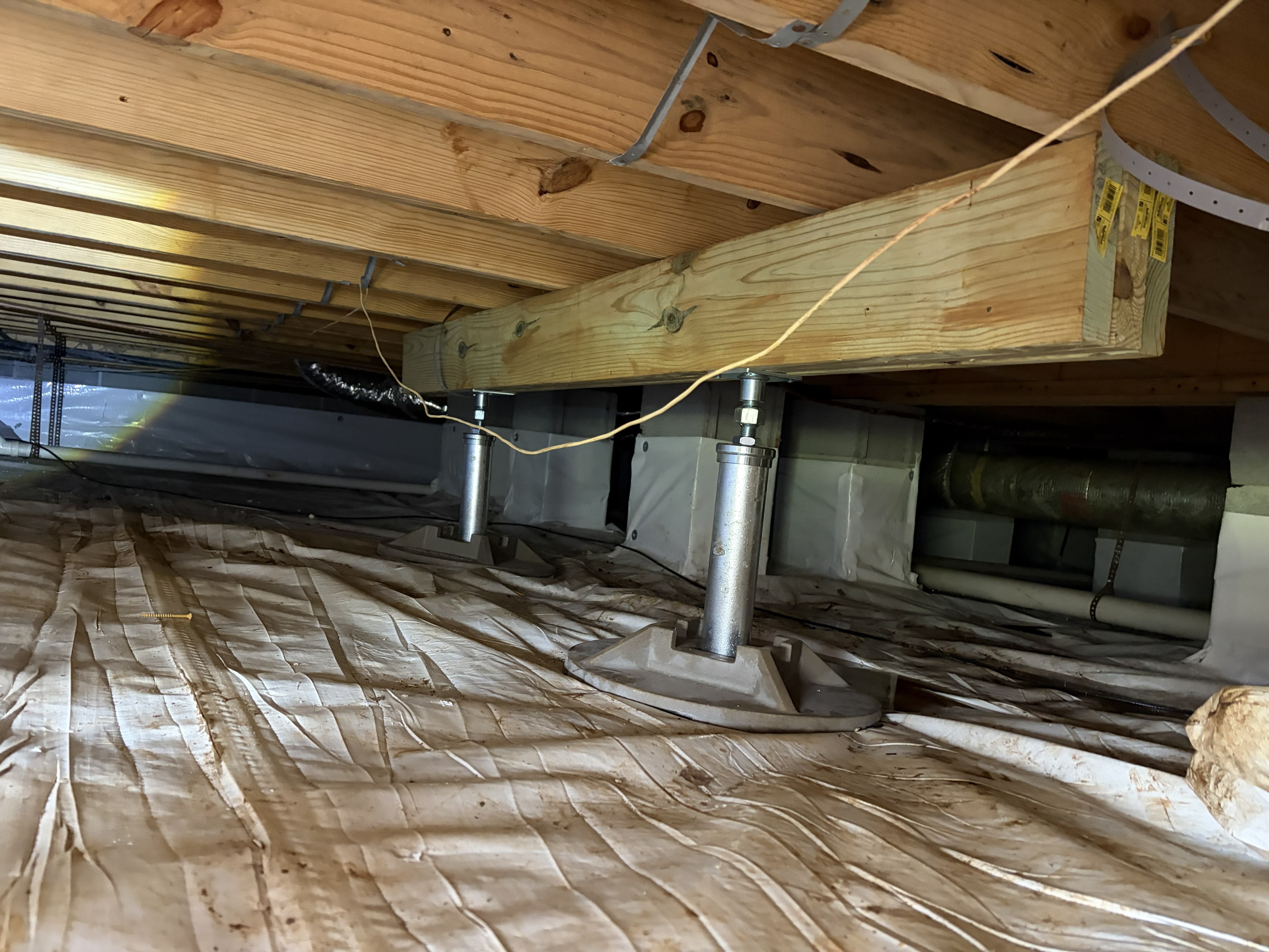 Floor support repair in Murfreesboro, TN — adjustable steel jack posts installed to support a sagging floor girder by The Crawl Shield