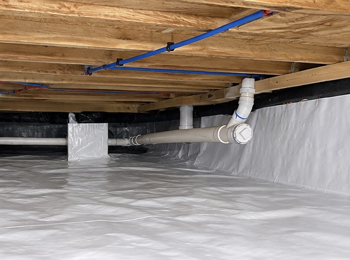 Clean, encapsulated crawl space with a white vapor barrier sealed across the floor and foundation walls in a Middle Tennessee home