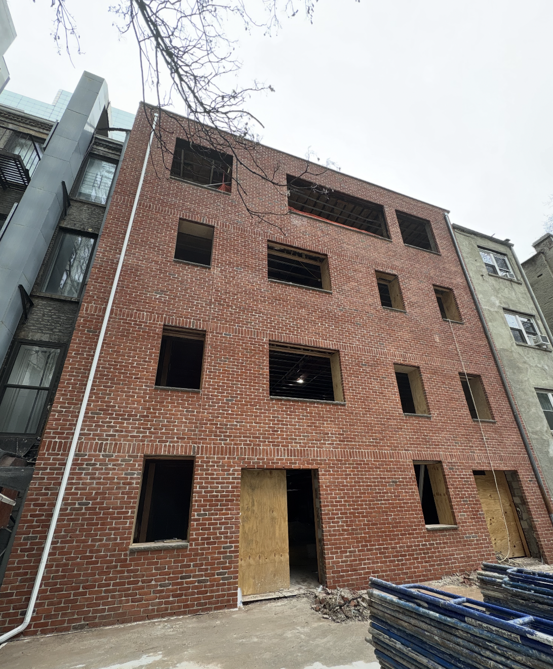 Completed four-story red brick rear facade with new window openings at the Seafire Grill 49th Street location in New York City
