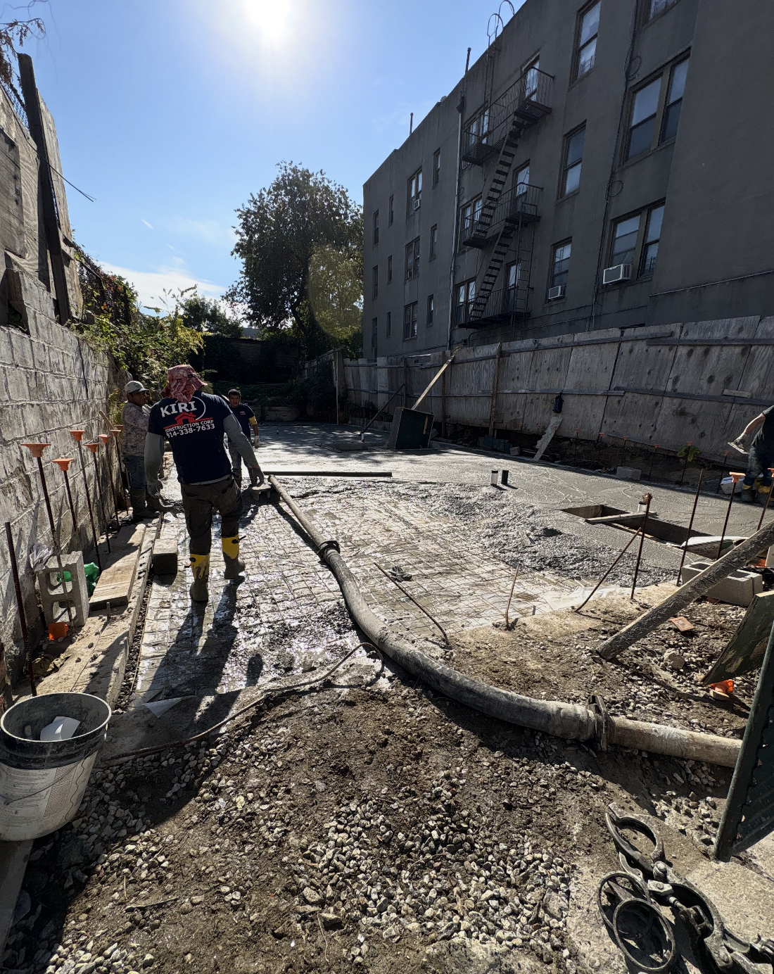 Kiri Construction crew pumping and finishing a reinforced concrete slab on East 216th Street in the Bronx, NY