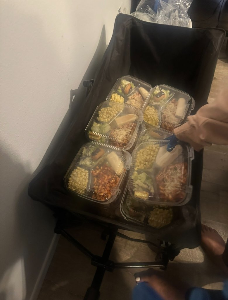 Volunteer packing meal containers into a wagon