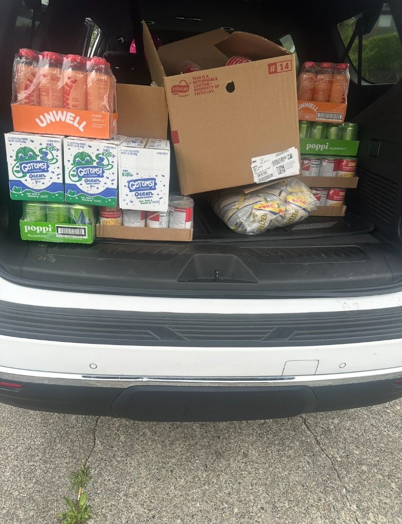 White vehicle trunk filled with food supply boxes