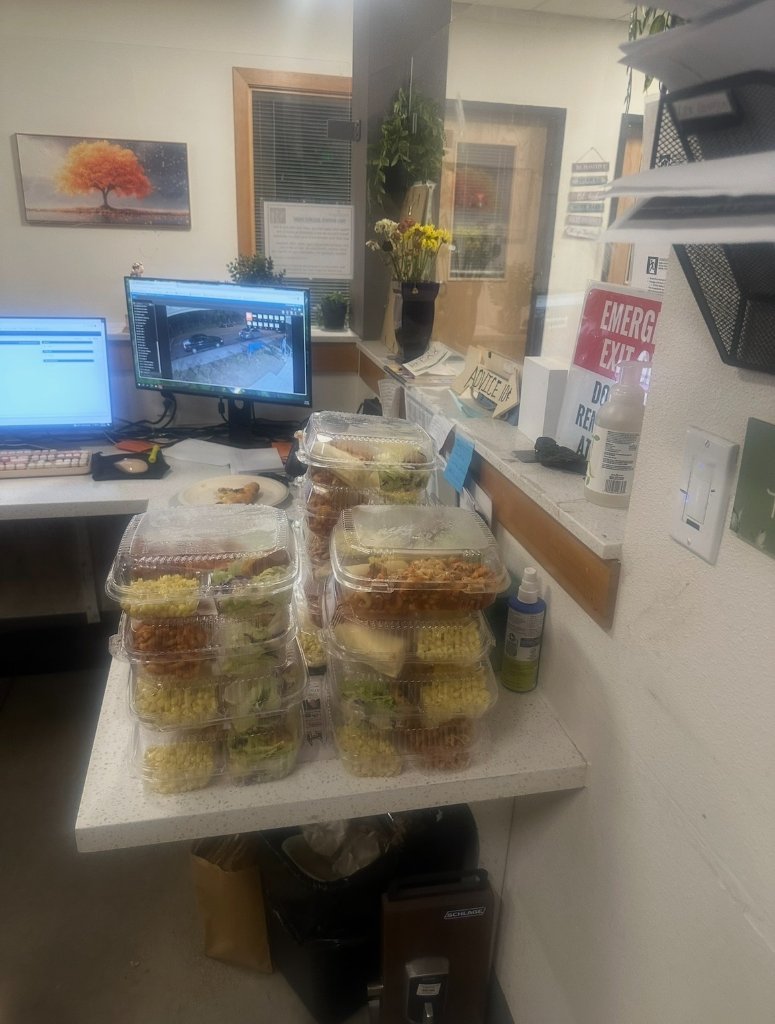 Workspace with stacked meal containers ready for distribution