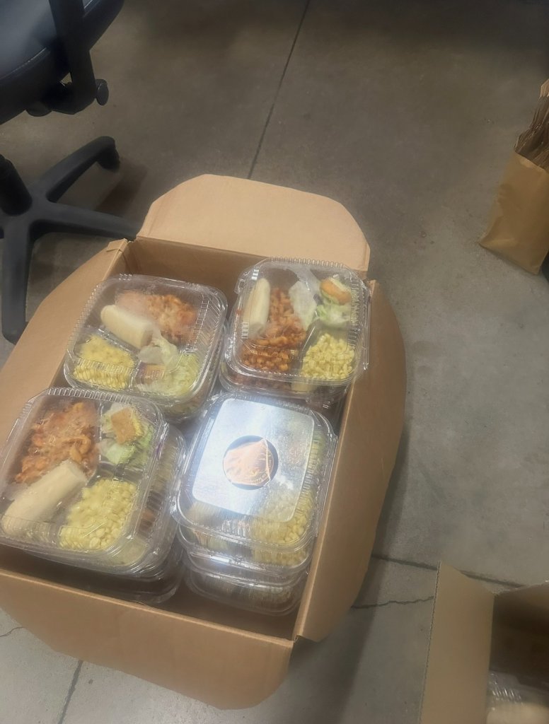 Box of pre-packaged meal containers with sides