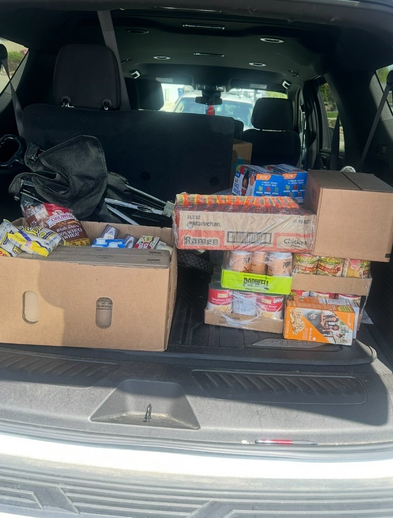 Vehicle cargo area loaded with boxes of food supplies