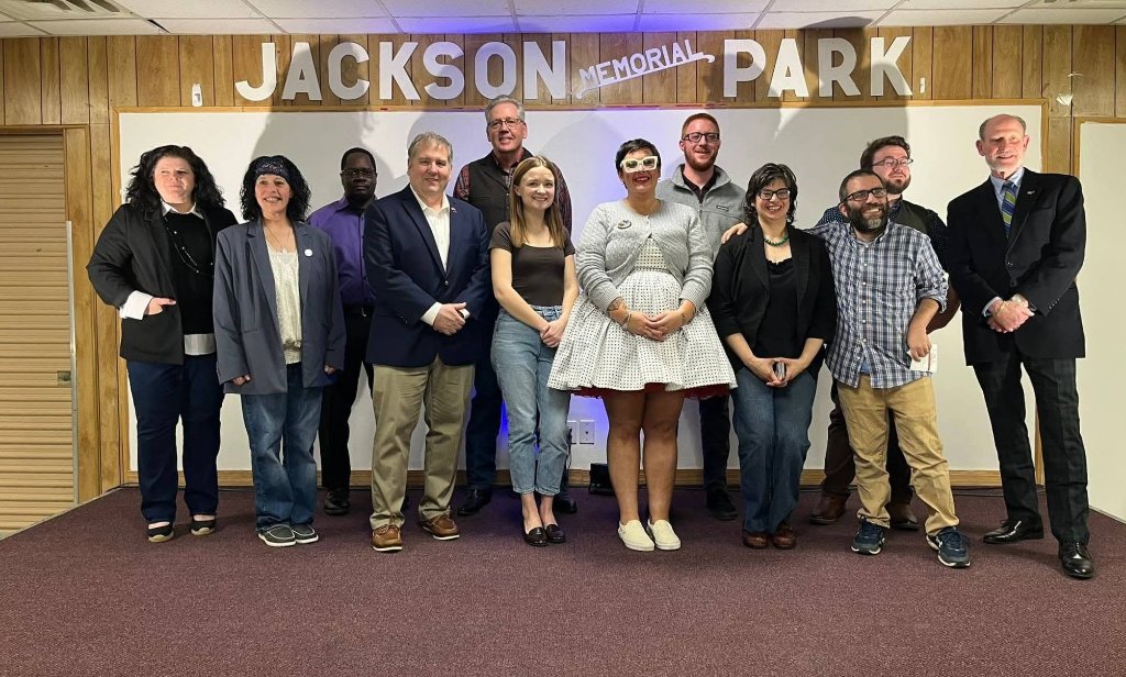 Crystal Butcher posing with a group of community members at Jackson Memorial Park, showing the strength of grassroots support
