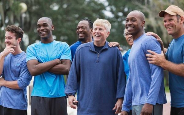 A group of men gathered outdoors, symbolizing connection, support, and the journey of recovery together