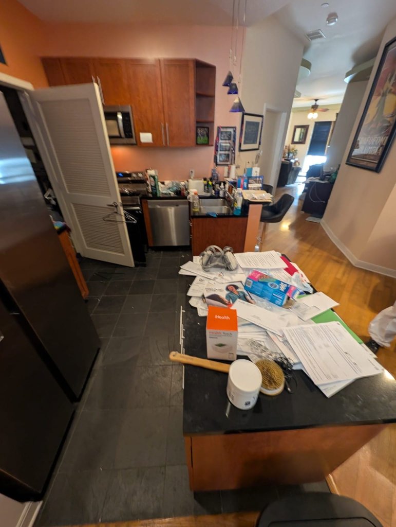 Cluttered kitchen counter before professional cleanup