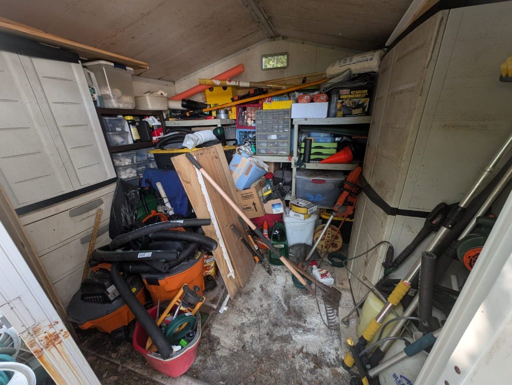 Cluttered storage shed before professional organization