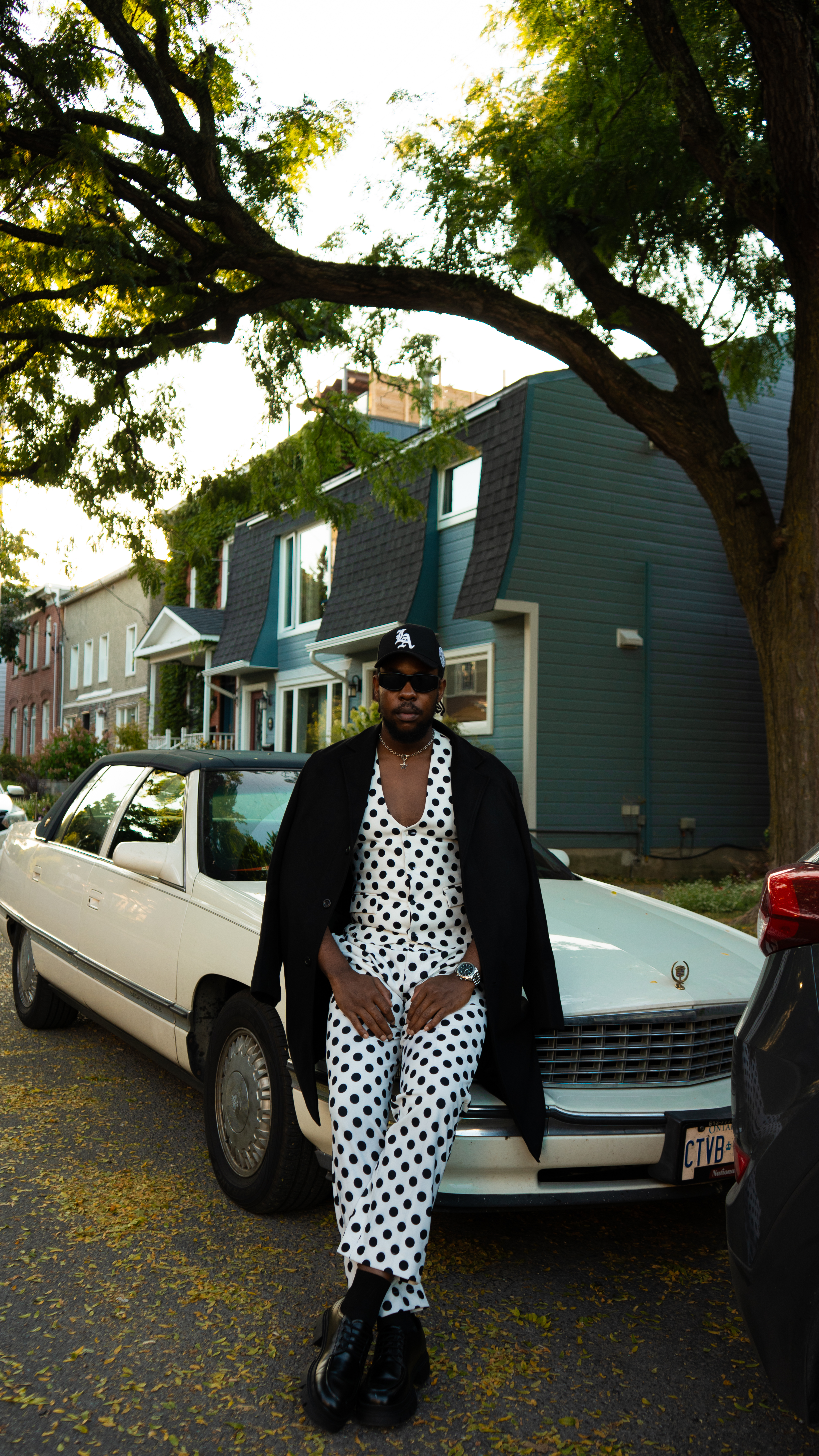 Fashion editorial, polka-dot outfit, white car, golden hour