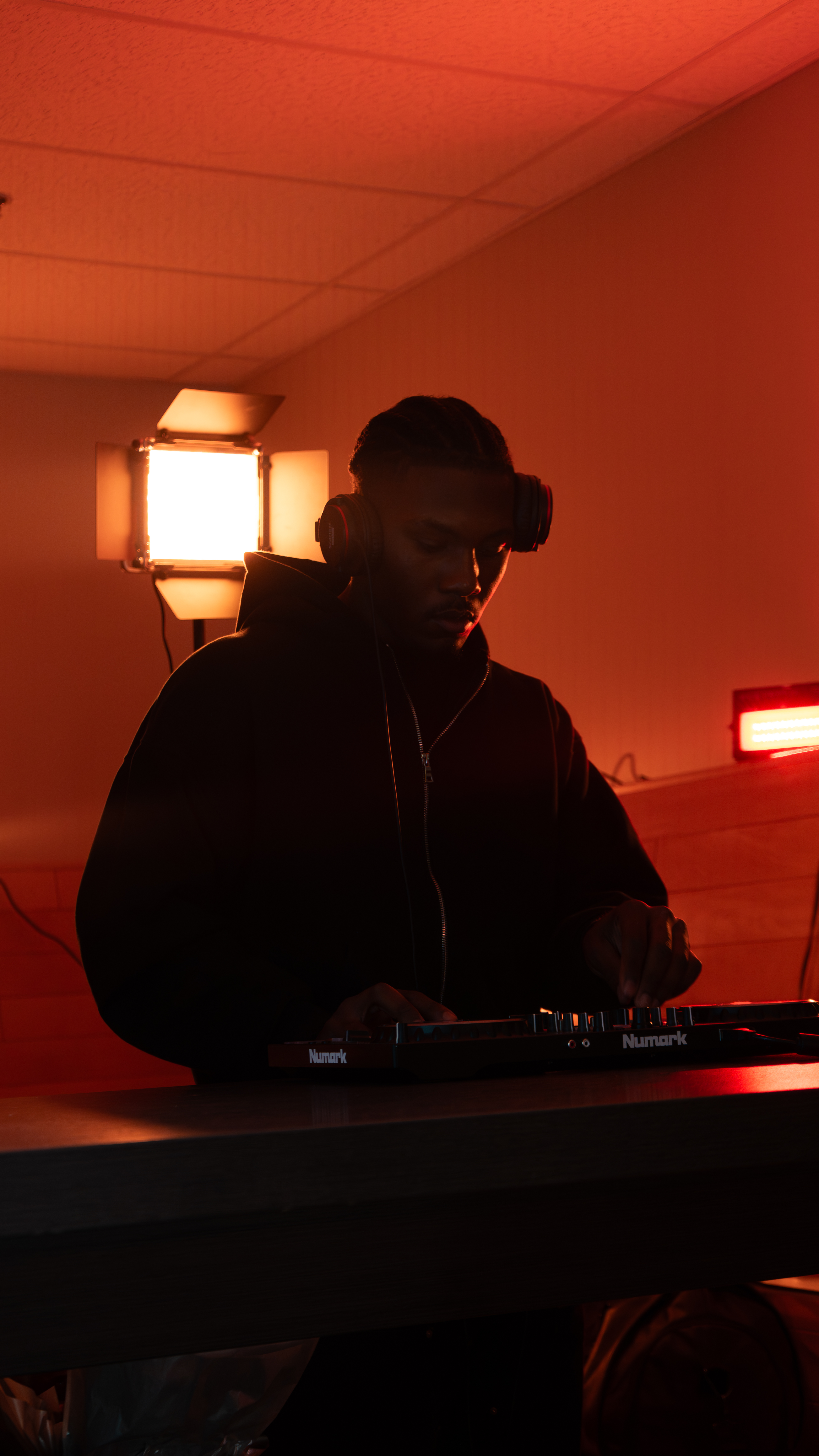 DJ at work, moody red lighting