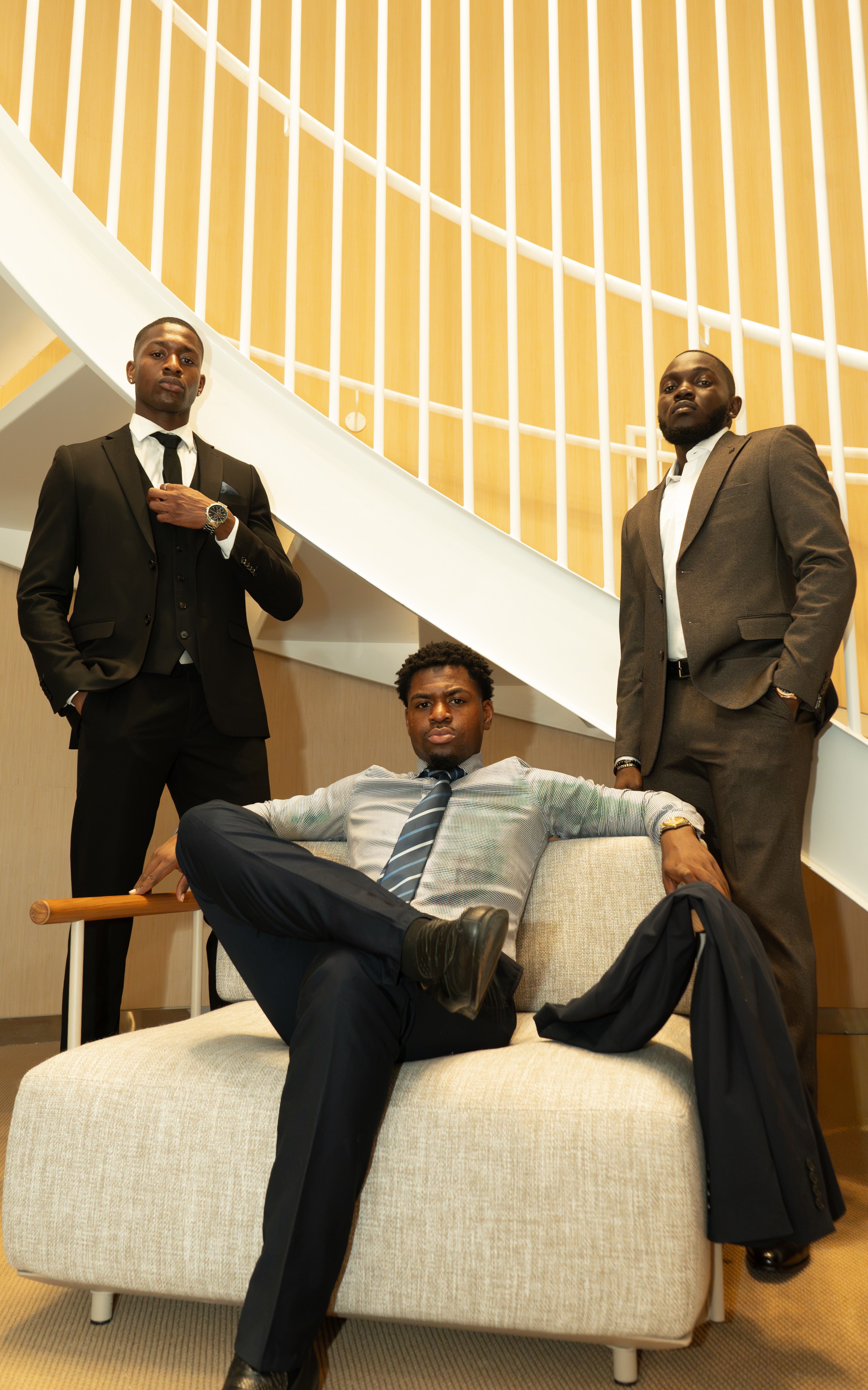 Three men in suits on staircase