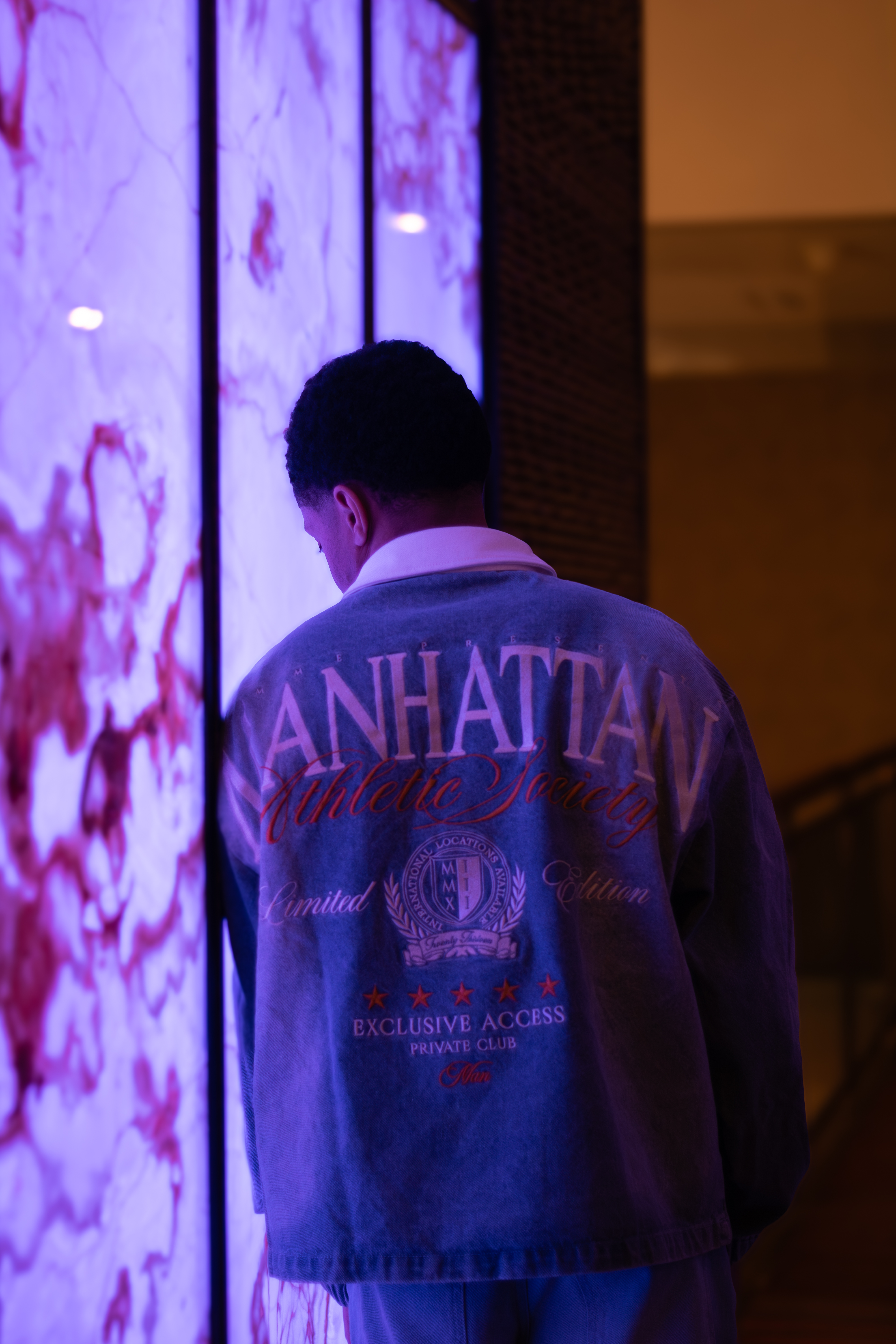Editorial, man backlit by purple light panel