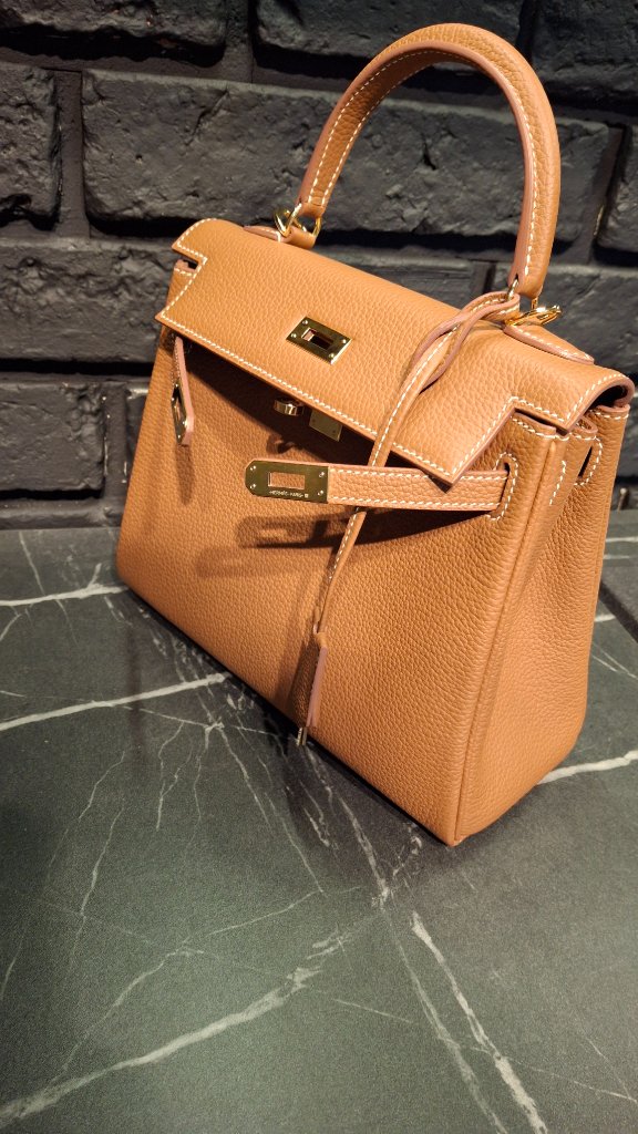 Close-up of the front of Hermès Kelly bag with hardware and lock