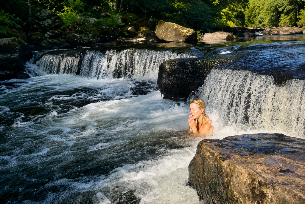 Woman in mountain stream