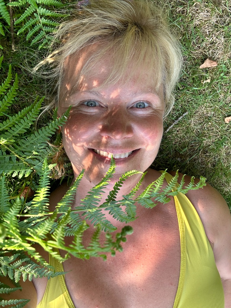 Vittoria at ease amidst ferns and sunlight