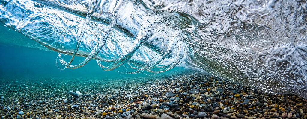Underwater wave breaking over pebble beach