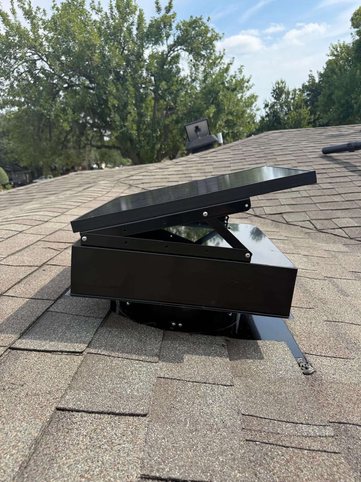 Solar attic vent installed on a residential asphalt shingle roof