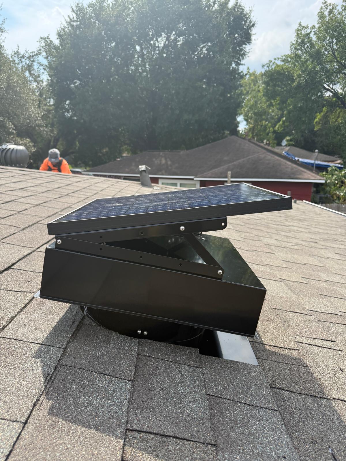 Solar-powered attic vent installed on a residential shingle roof in Houston, Texas