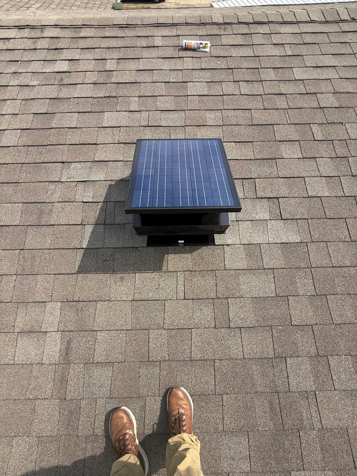 Solar attic vent installed on a residential shingle roof