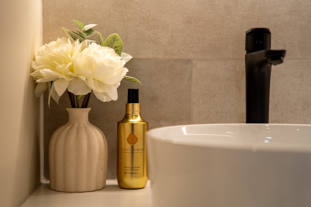 Washroom vanity with peonies and home perfume