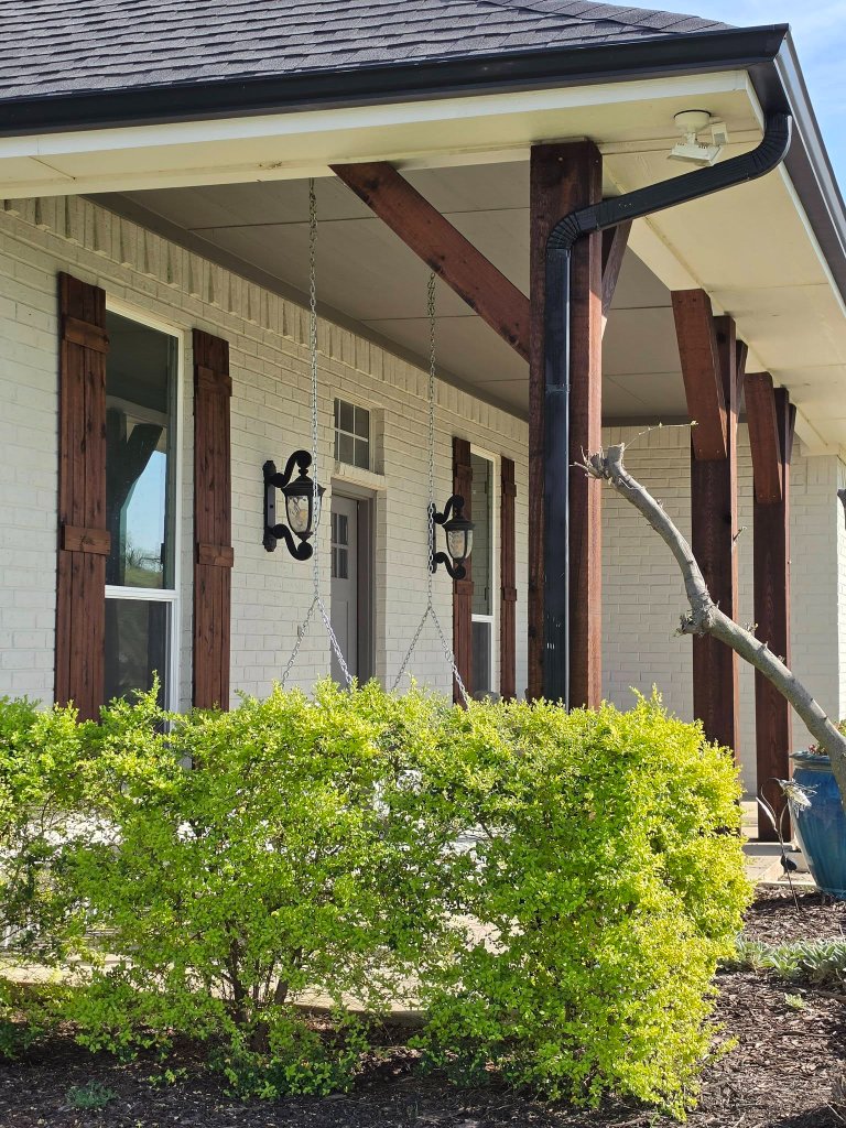 Fence restoration project with wood brightener applied