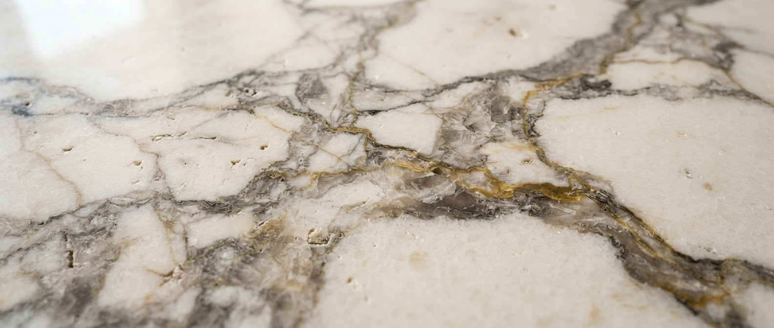 Macro texture of Calacatta Borghini marble with golden veining