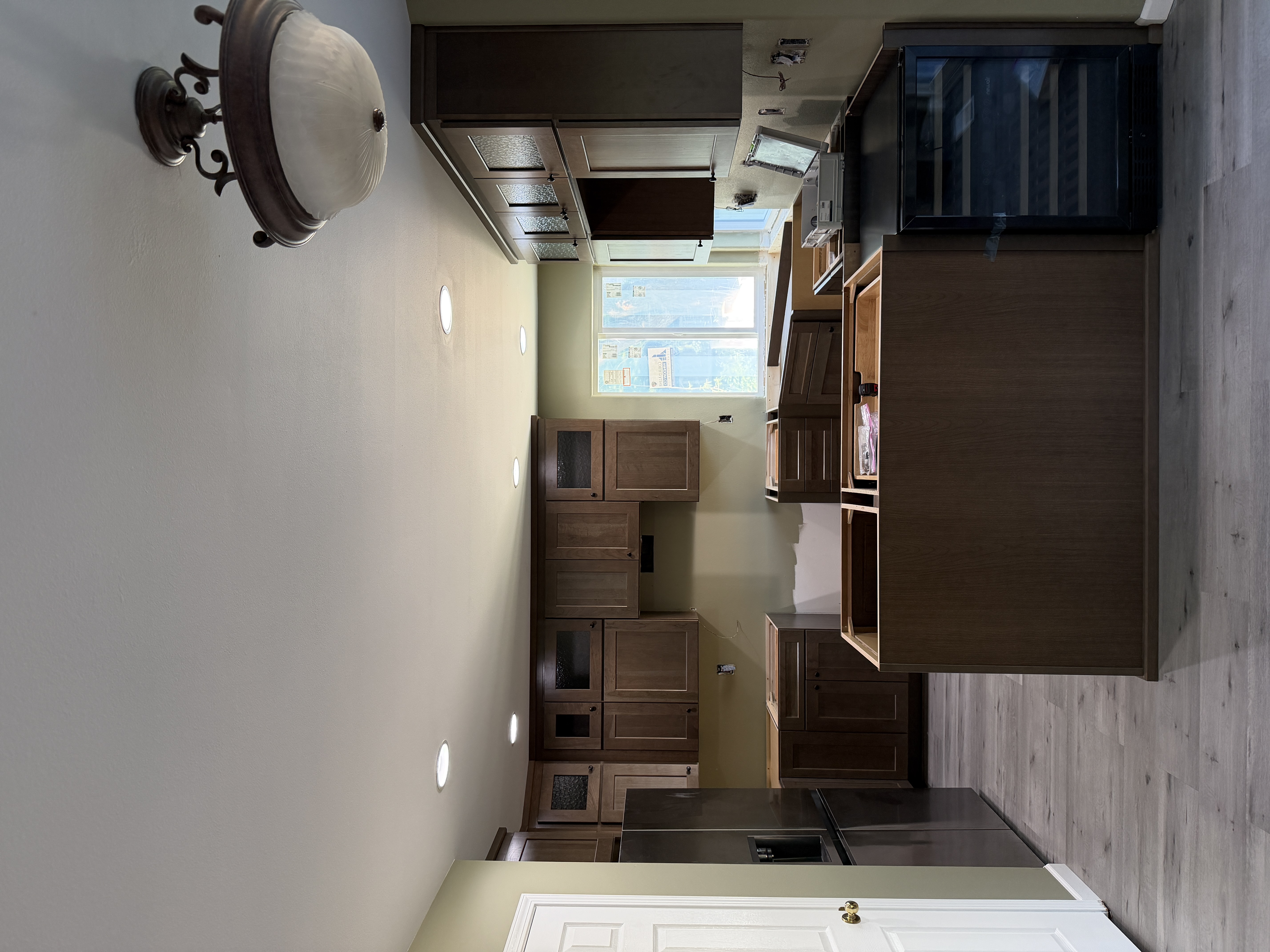 Dark wood Shaker kitchen with glass-front uppers
