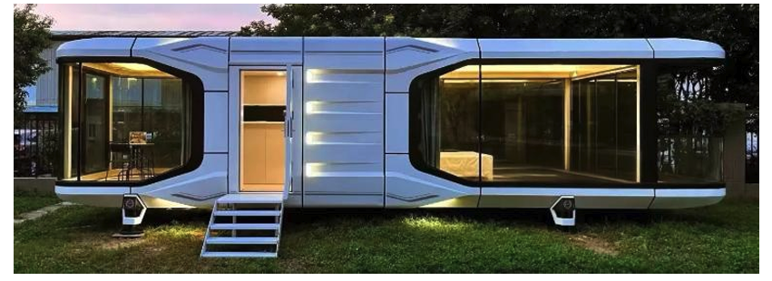 Spaceship — A futuristic modular dwelling with sleek white panels, floor-to-ceiling glazing, and warm interior lighting. Fully prebuilt and ready for rapid on-site installation.