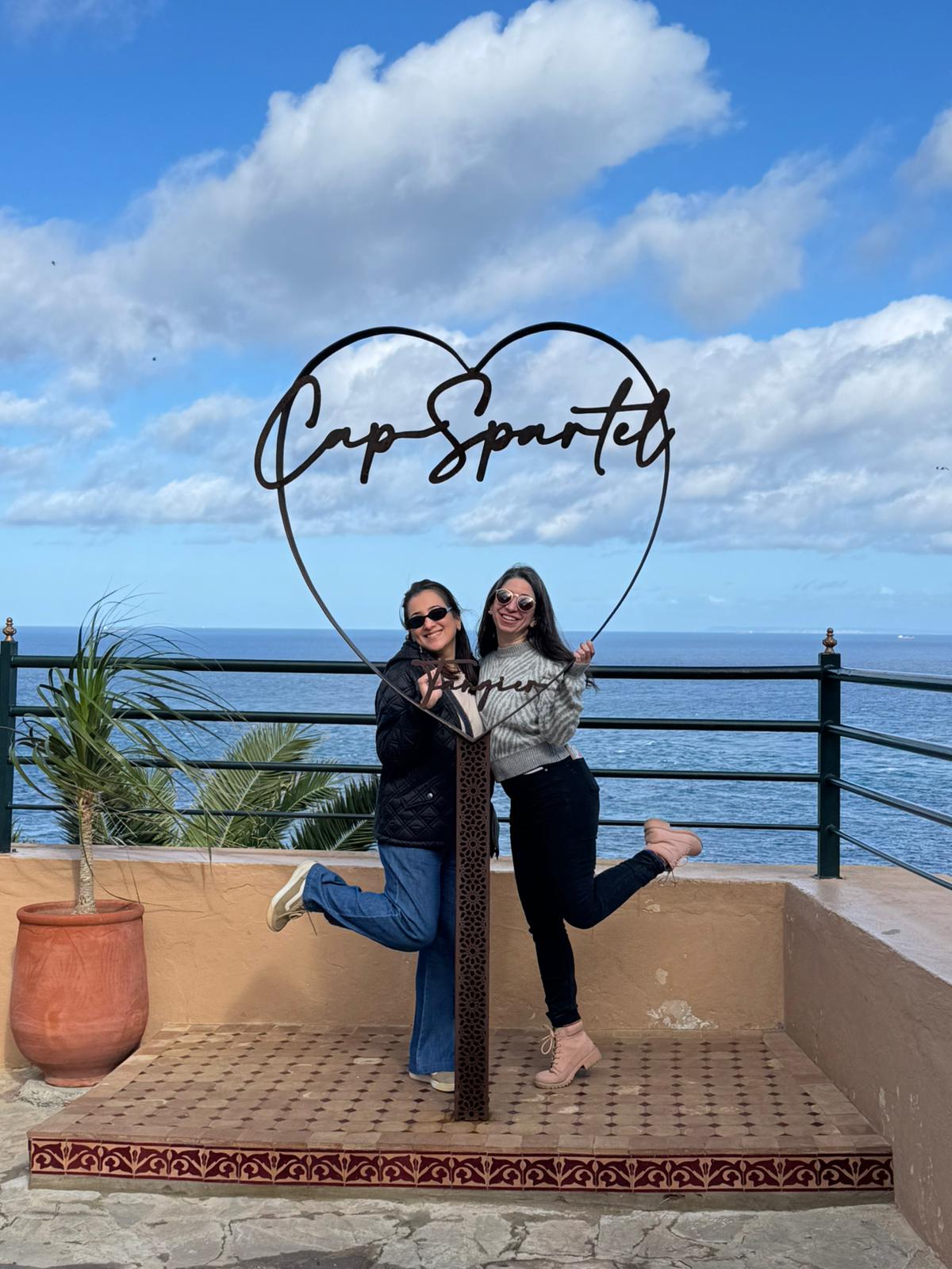 Retreat guests posing at the Cap Spartel heart sculpture