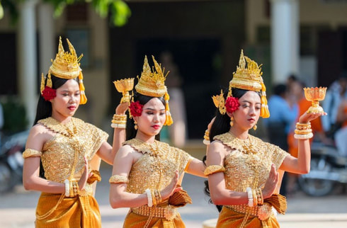 Apsara dancers in traditional Khmer attire performing at a Cambodia retreat dinner