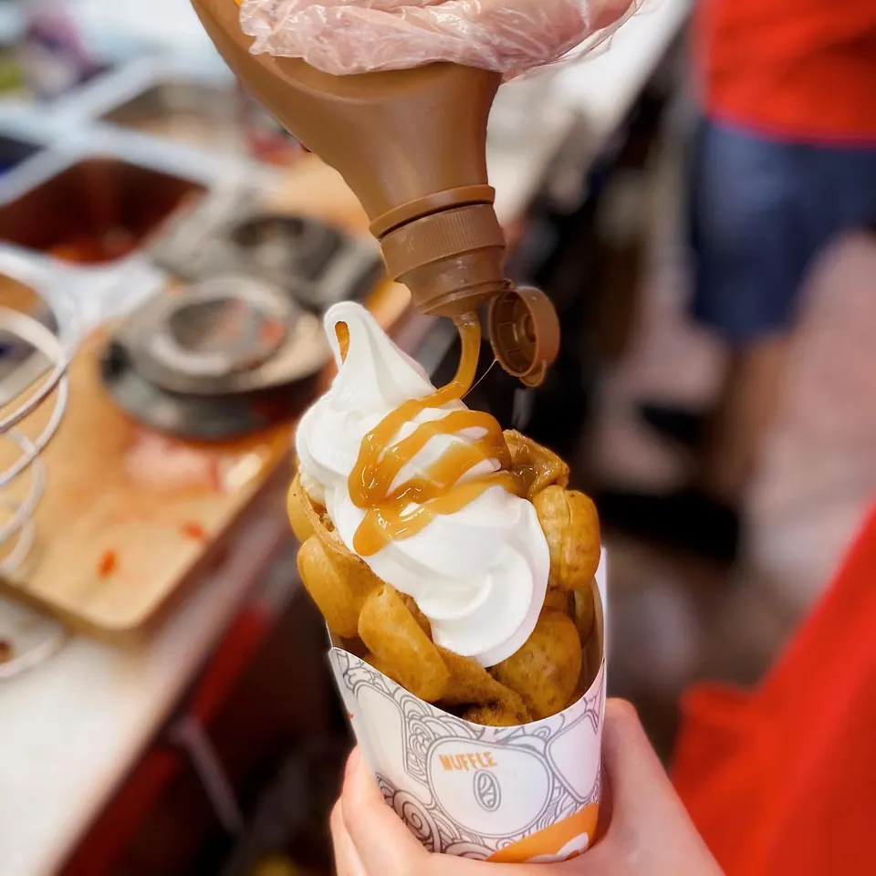 A sauce drizzle finishing a freshly made Muffle and soft serve