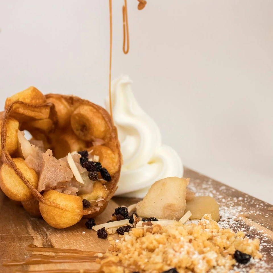 A golden Muffle served with soft-serve ice cream, fruit and crumble