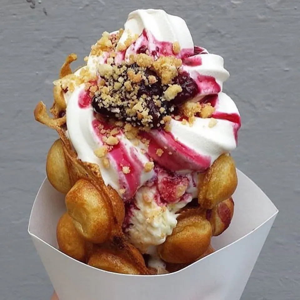 A Muffle with soft serve, berry sauce and crumble