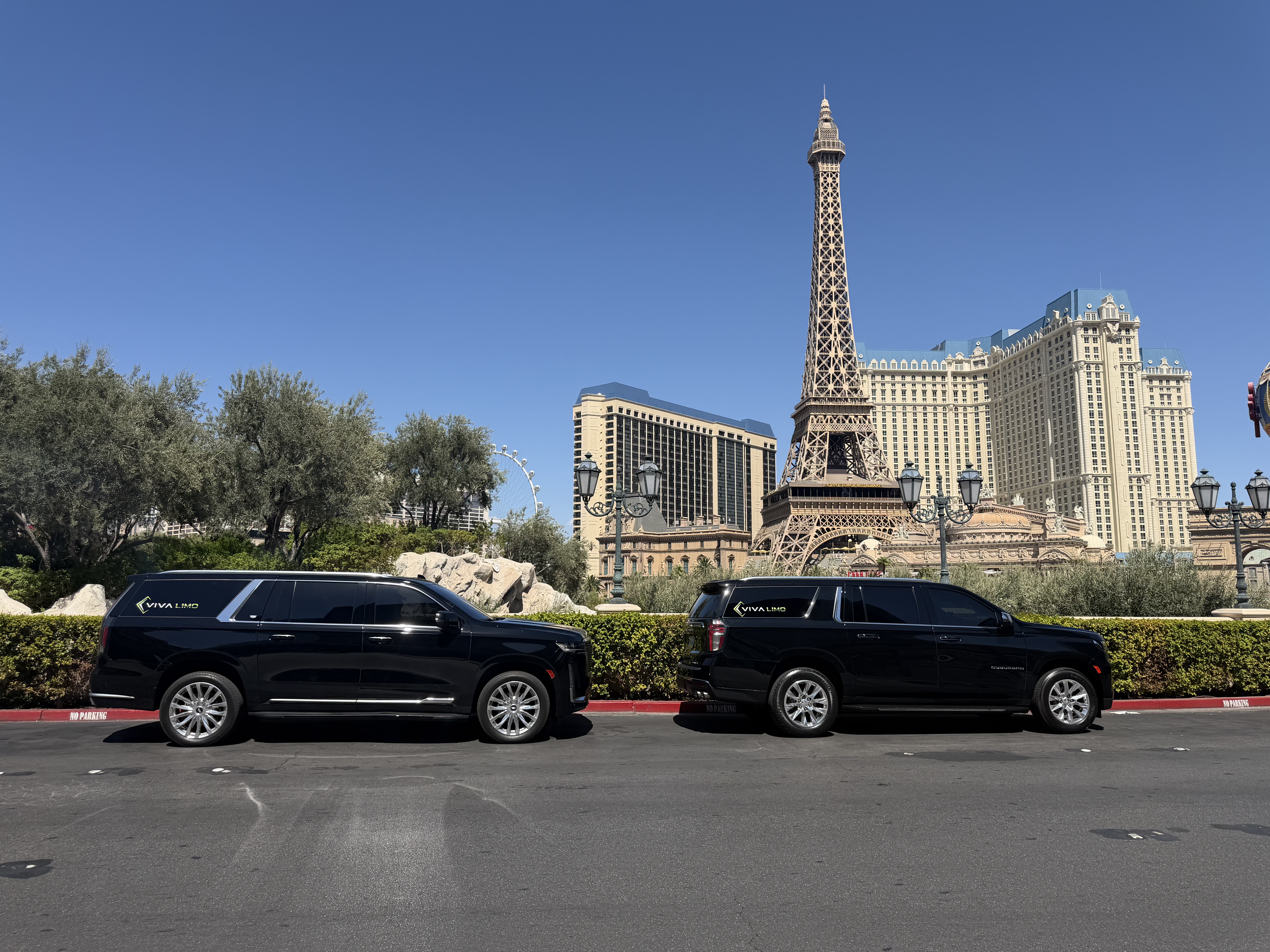 Two black Viva Limo SUVs parked at Paris Las Vegas with the Eiffel Tower