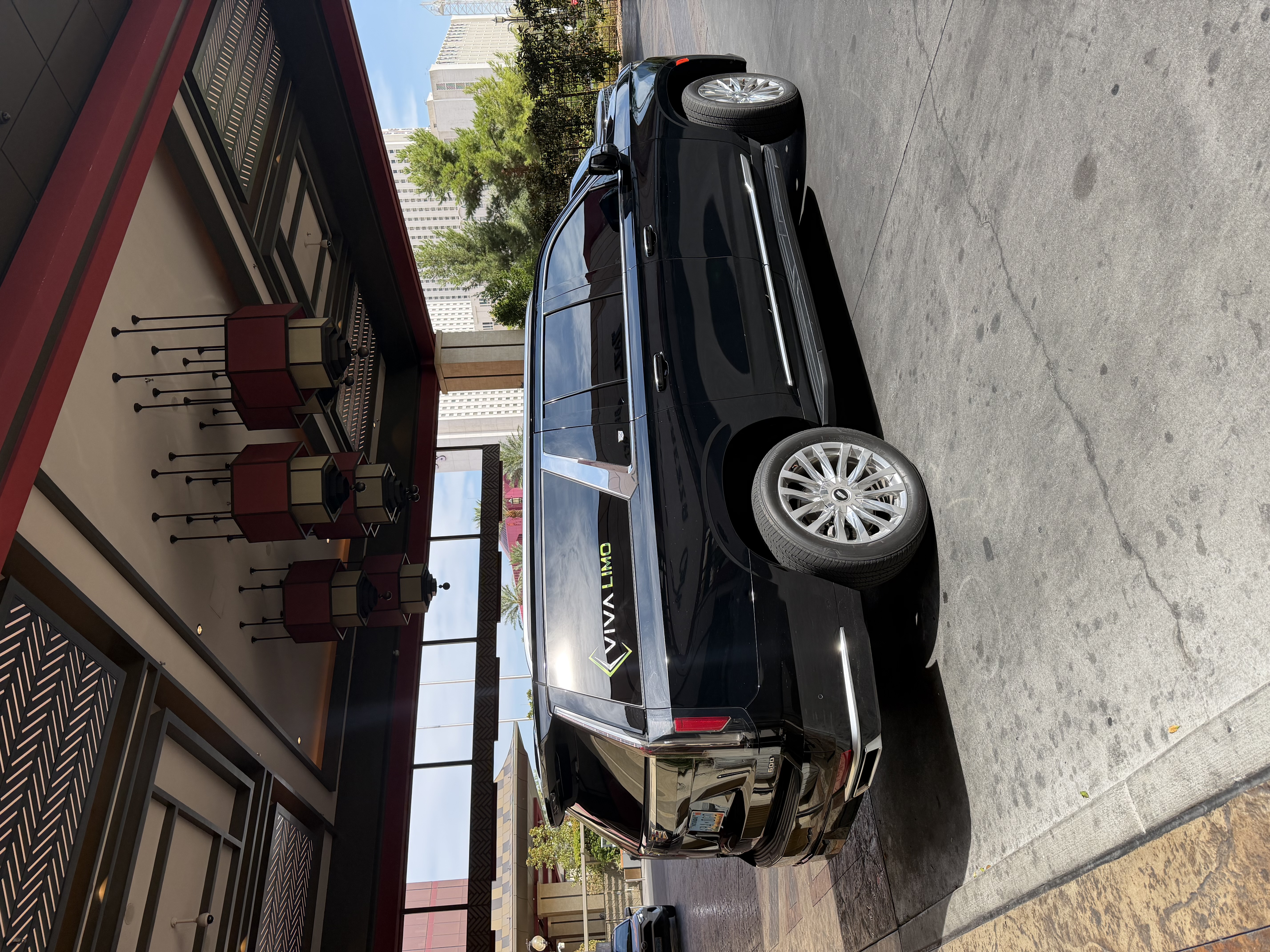 Black Cadillac Escalade SUV at a luxury Las Vegas hotel valet entrance