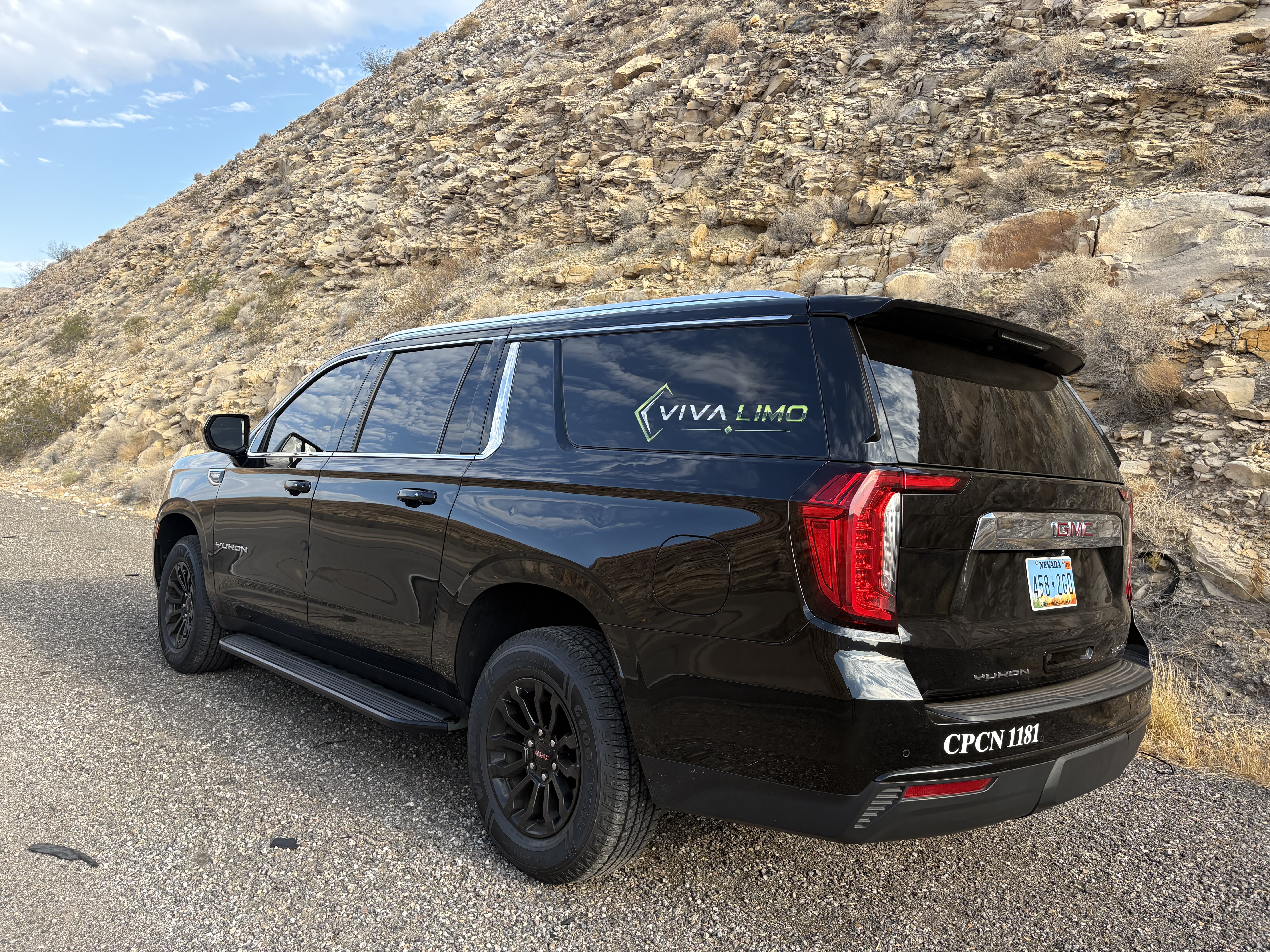 Black GMC Yukon SUV rear three-quarter view in the Las Vegas desert with Nevada plate