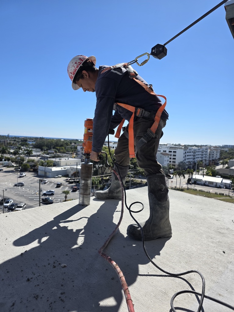 Core drilling contractor drilling into a concrete rooftop in South Florida
