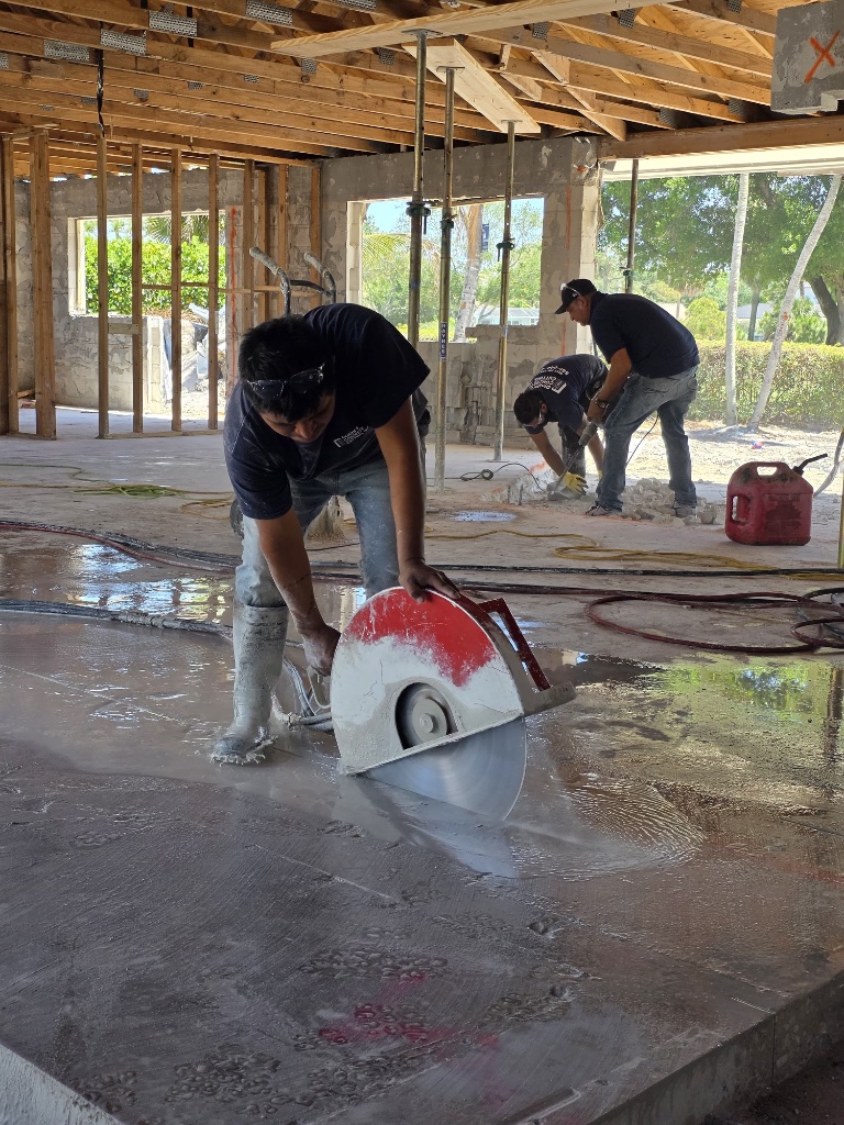 Concrete cutting crew slab sawing inside a building under construction in South Florida