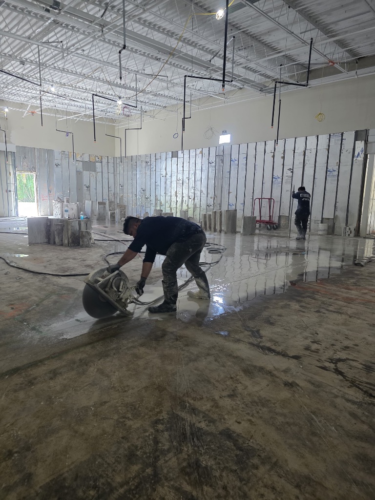 Concrete saw cutting on a wet slab at a South Florida construction site