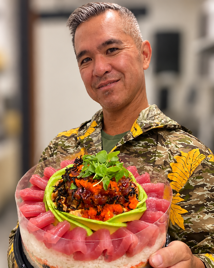 Chef Ernie Gray Jr. holding a Poke Market sushi cake