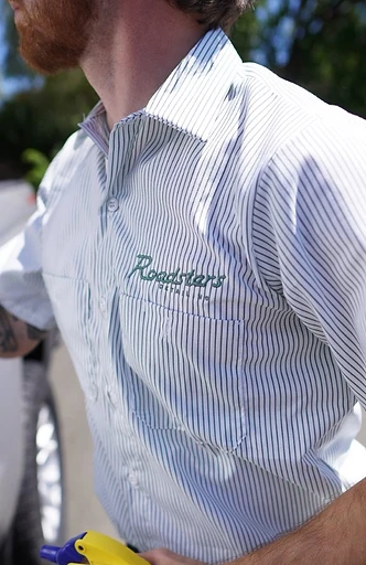 A Roadsters technician wearing the embroidered shirt logo