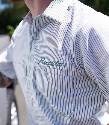 A Roadsters technician wearing the embroidered shirt logo