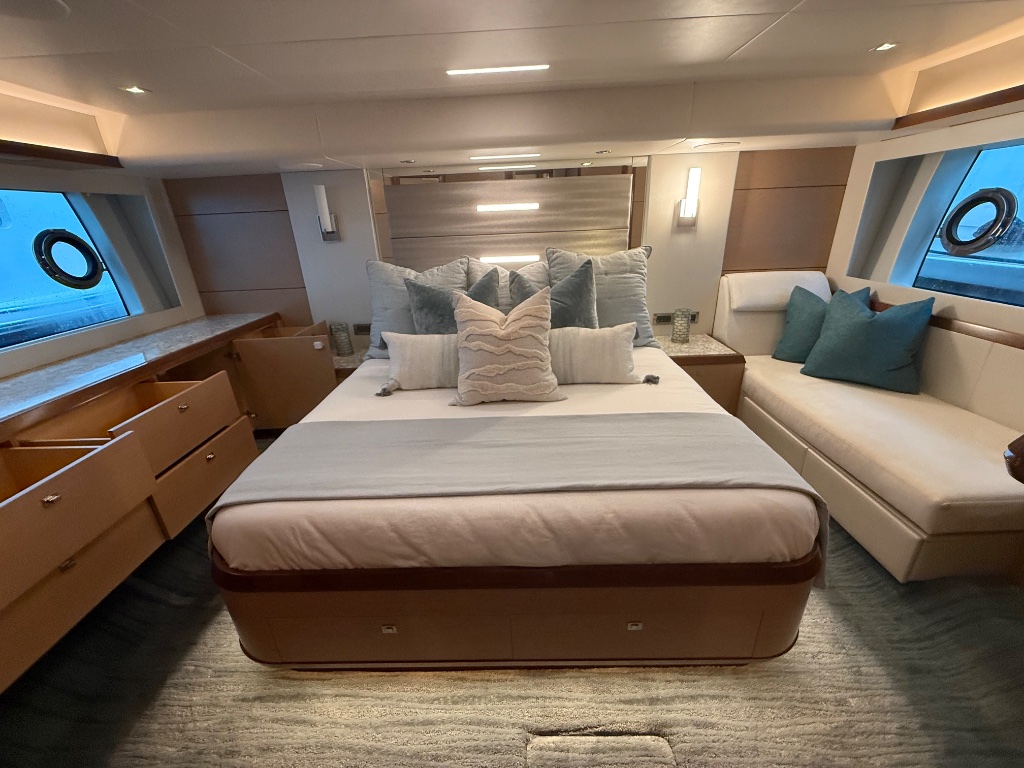 Luxury yacht master stateroom staged with fresh linens and decorative pillows after professional detailing for FLIBS