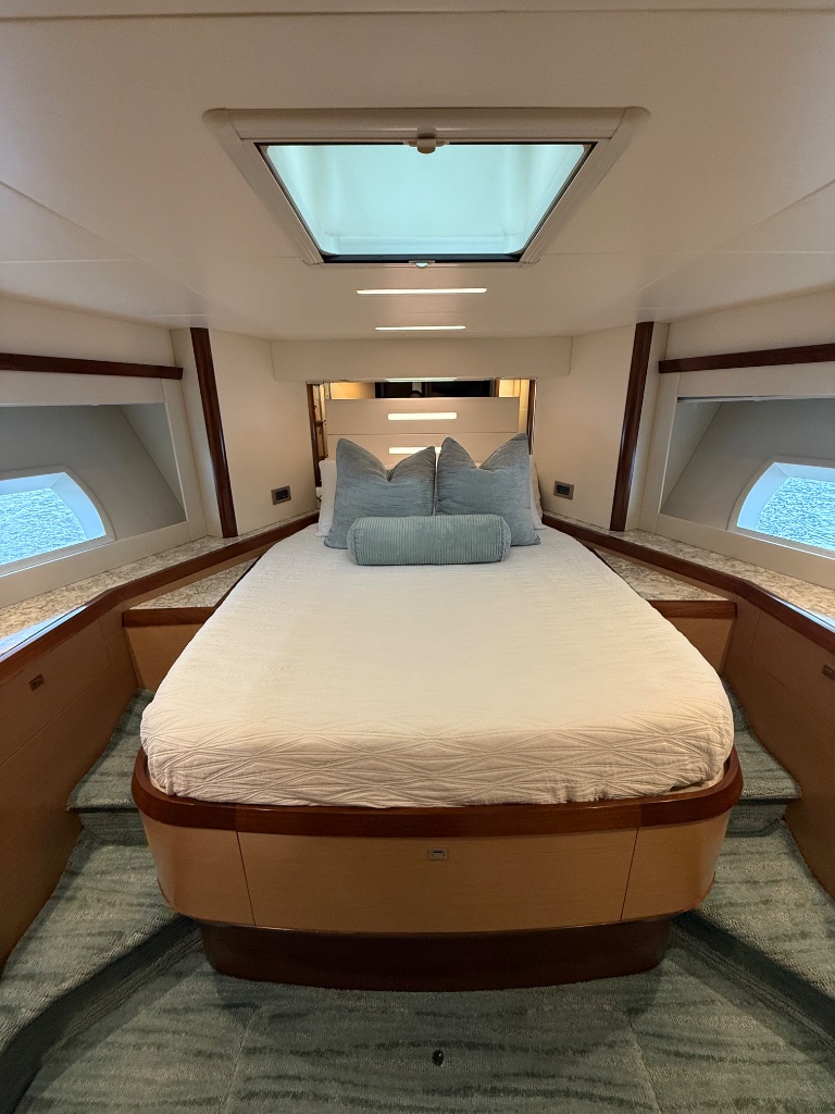 Yacht guest cabin bed freshly made with clean linens before the Fort Lauderdale boat show