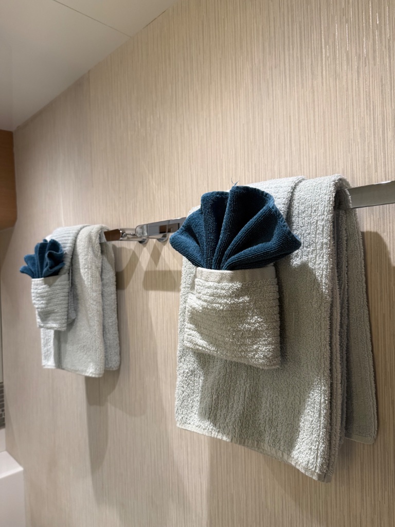 Folded towel presentation in a yacht bathroom highlighting pre-show housekeeping and detailing