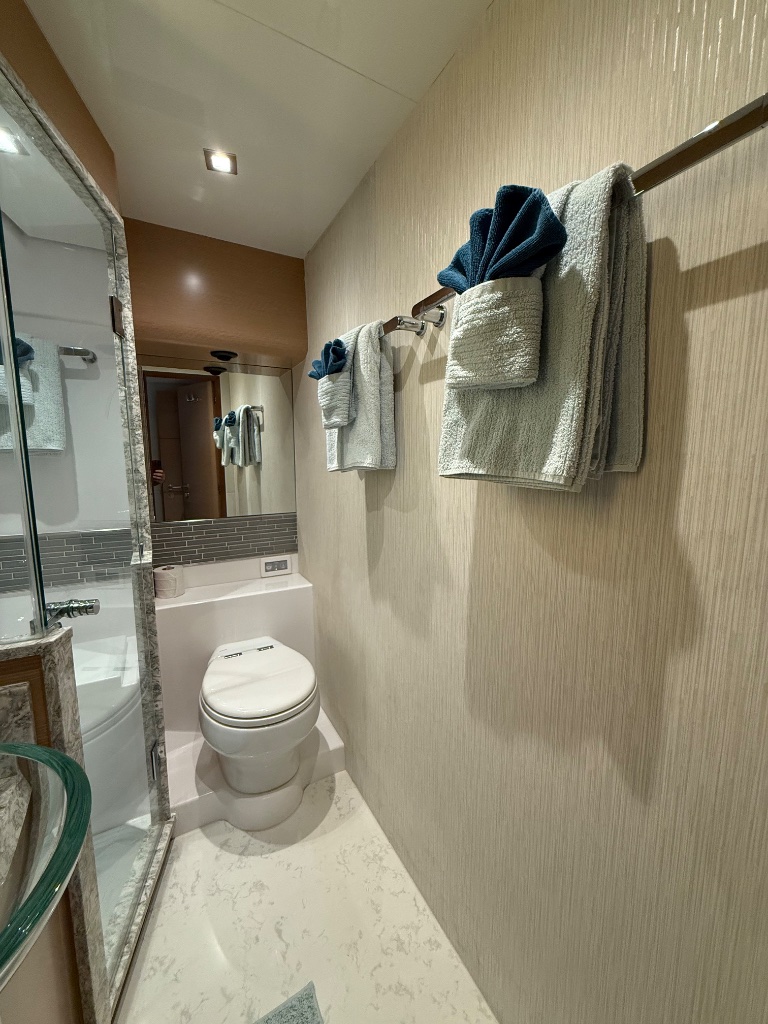Yacht head bathroom with neatly folded towels after professional detailing for FLIBS